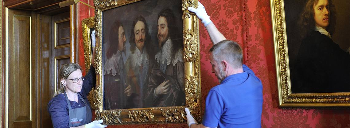 Painting being  moved by art handlers