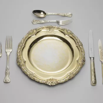 A set of silver-gilt plates; the reeded rim cast with fruiting vines and scallop shells. The plate is engraved with the Royal coat of arms, with supporters, mantling and coronet.