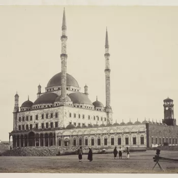 View of Mosque of Mohammed Ali in Cairo, Egypt. Alabaster building seen across square, with 2 tall minarets centre. Single row of columns supporting round arches lining court, left.

The mosque was built in the Ottoman style between 1830 and 1848 for th