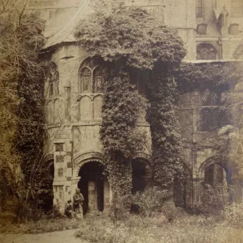 Boy and man in front of a large stone building