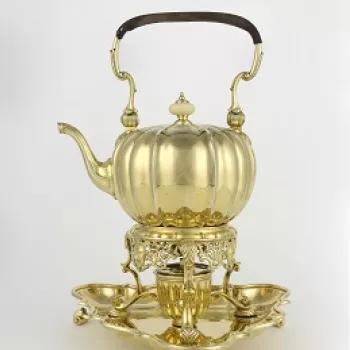 A silver gilt melon-shaped tea kettle and stand, with a bail handle with leather grip, a hinged lid with ivory knop handle and a swan-neck spout; the body is engraved with stylised strapwork. The stand, fitted with a burner, has a pierced apron and three 