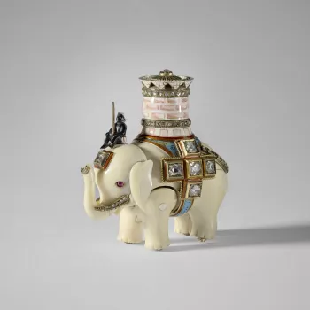 An ivory elephant with separate, jointed body legs&nbsp;and head, ridden by an enamel man sitting on its head&nbsp;and carrying a pink&nbsp;and white enamel castle with two&nbsp; rose cut diamond set bands&nbsp;and a pierced upper rim, the top set with a 