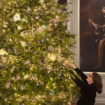 Royal Collection Trust staff member makes final adjustments to the Christmas tree in the Great Gallery at the Palace of Holyroodhouse