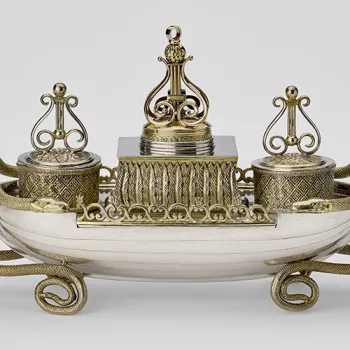 A silver inkstand in the form of a rowing boat 